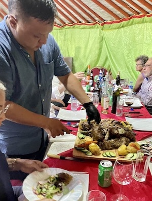 Mongolian mutton being cut for a group meal