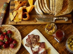 Charcuterie board with bread, spreads, cheese and meats