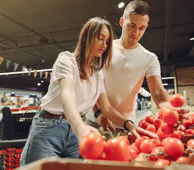 Man and woman shopping for tomatoes