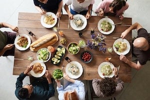 People gathered around a table eating