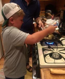 Great nephew Tanner preparing his "catch of the day" at the family cabin