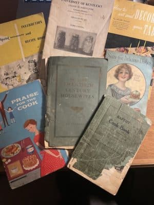 Selection of vintage cookbooks sitting on counter