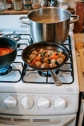 Pans cooking on stove top
