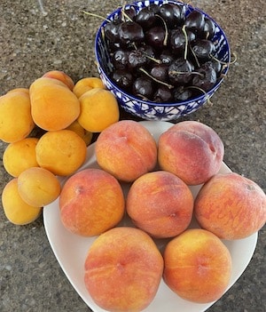 Peaches and cherries on the counter